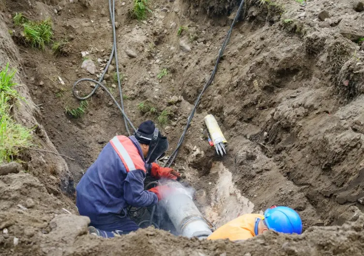 Men Welding a Sewer Line
