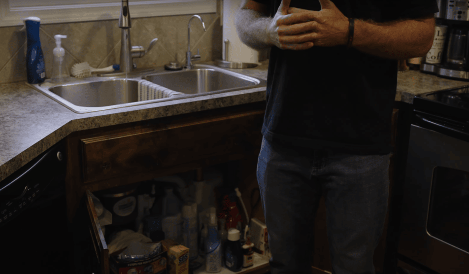 An image of a person standing in the kitchen